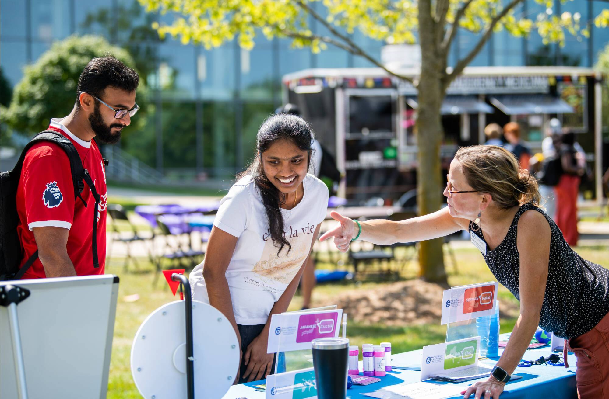 Aparna Devabhaktuni, left, joined the Global Laker Festival for lawn games, international music, snacks, and other activities in front of the carillon tower September 4. Devabhaktuni is a graduate student majoring in health informatics and bioinformatics.